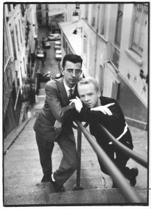 Black and white photo of the Communards on some steep looking steps.