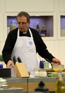 Richard in apron on set of of Masterchef