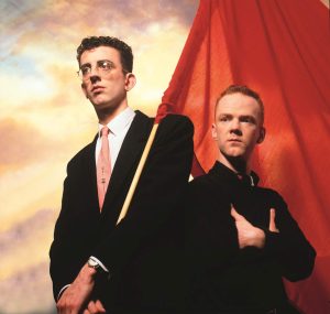 Publicity photo of The Communards. Richard holding the Red Flag. Jimmy with his arms folded.