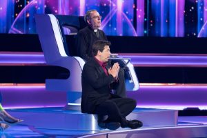Richard sat in a big metal chair on the set of the wheel. Michael McIntyre sat on a